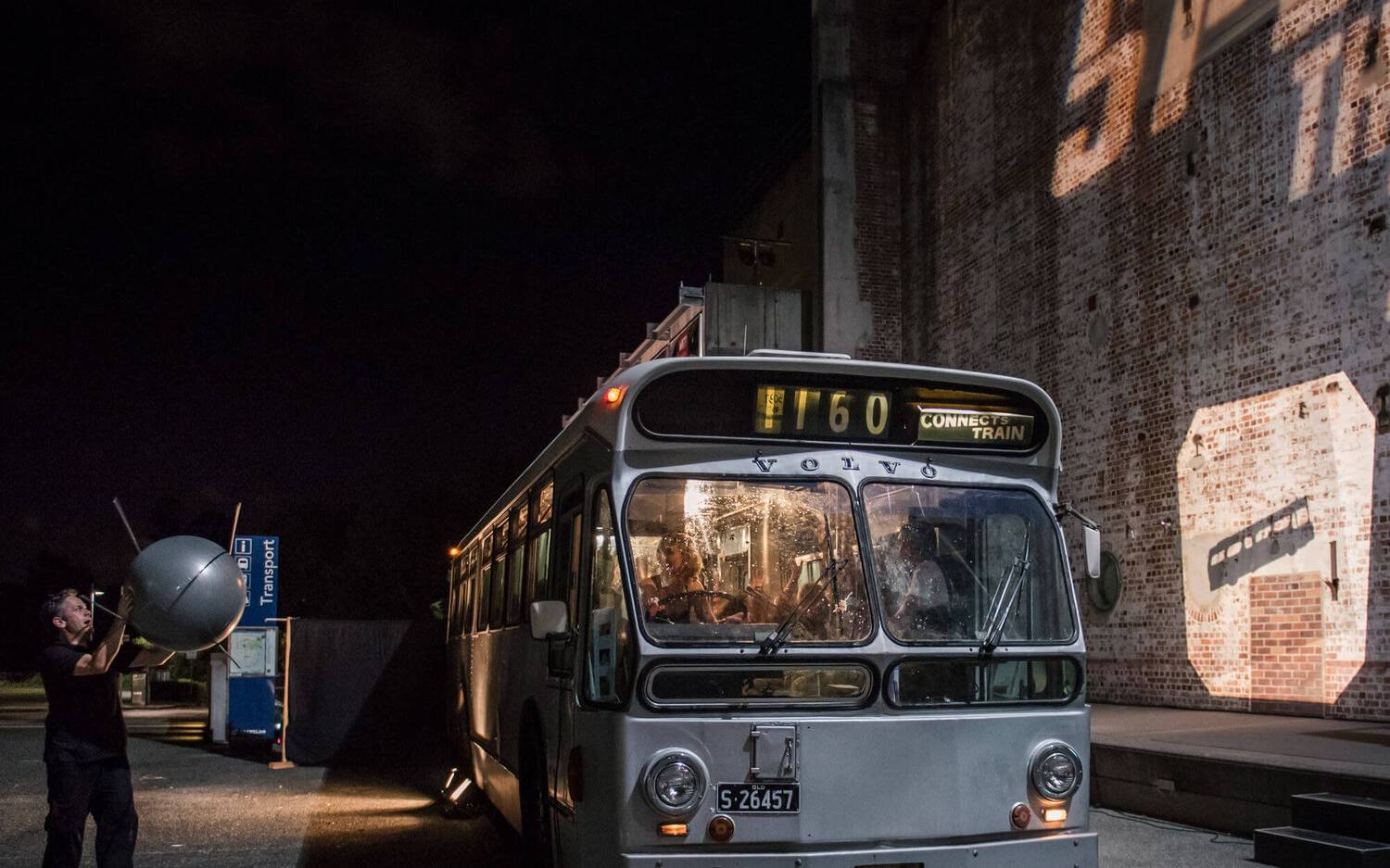 An actor holding a Sputnik prop for Speed: The Movie, The Play performance